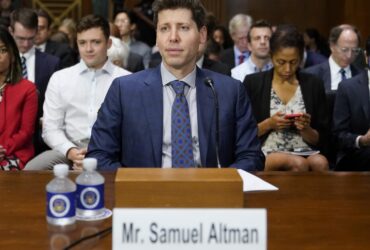 a man sitting at a table with other people