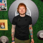 ed sheer poses for a photo at the music awards